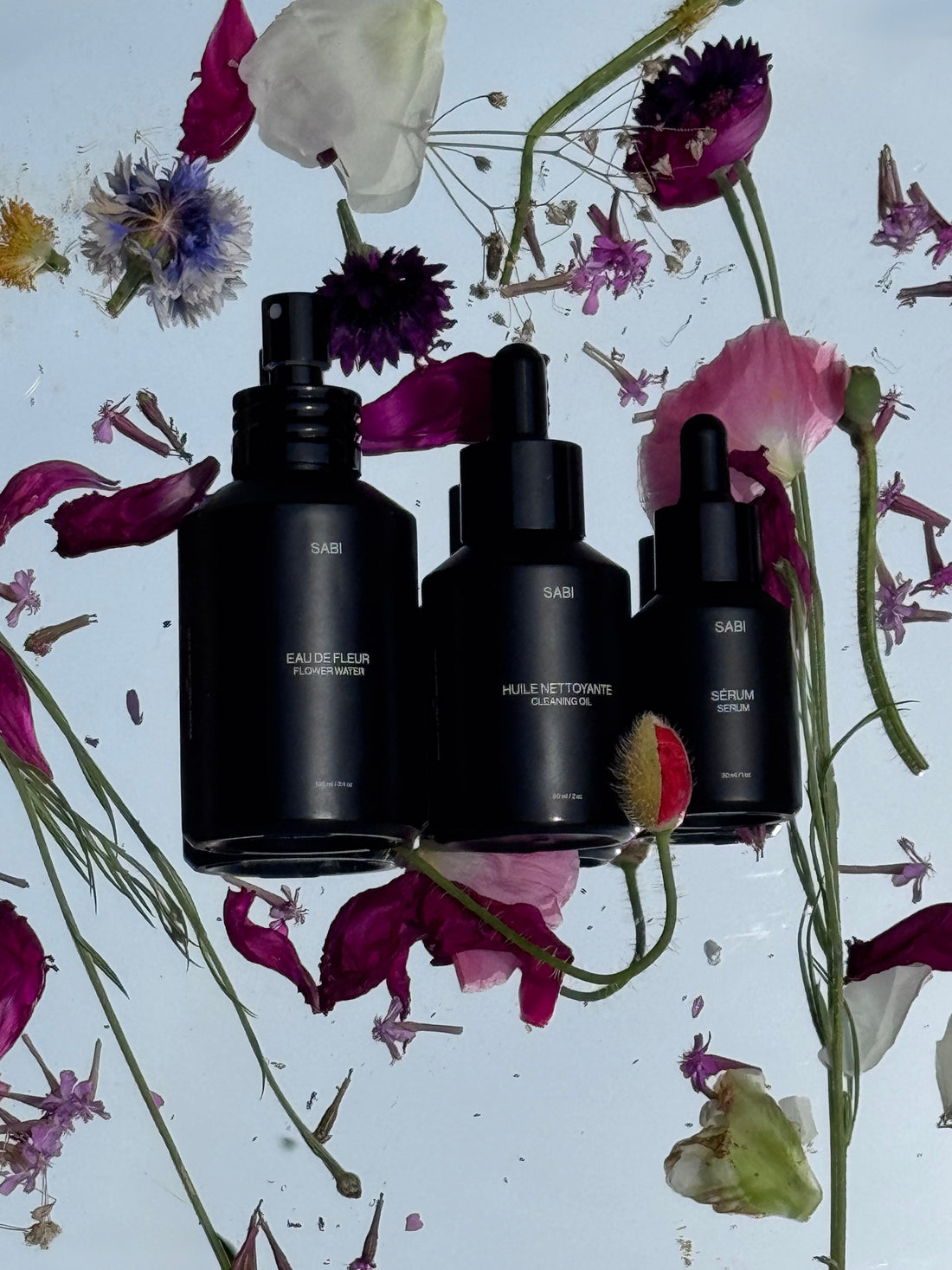 3 black product bottle on a flower background