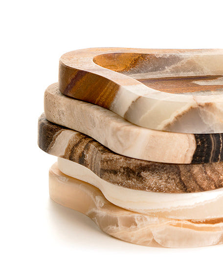 Stack of marbled stone coasters on a white background