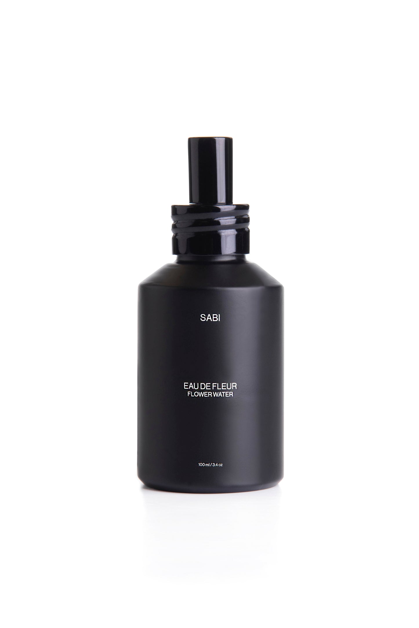 SABI Flower Water - hydrating and soothing plant-based face mist made with organic floral hydrosols and wildcrafted botanicals.
A black matte glass bottle with a black spray nozzle labeled 'FLOWER WATER', indicating it is a skin mist product.
