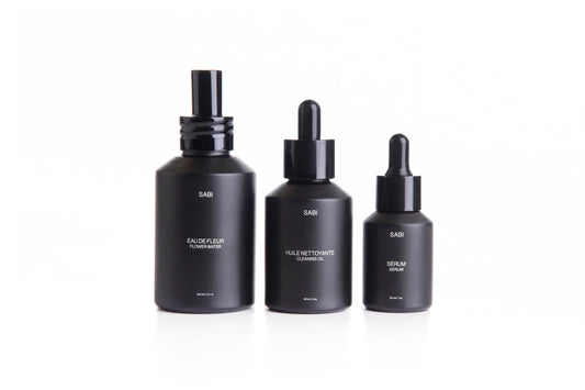 Complete SABI Botanical Ritual Trio – Cleansing Oil, Flower Water, and Ritual Serum set designed for a luxurious, 100% natural skincare ritual. Three black matte glass bottles with dropper caps. SABI Ritual Serum – high-performance vitamin-rich serum with 28 nutrient-dense botanicals, crafted to nourish, protect and revitalize radiant skin.